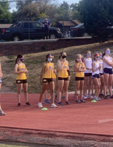Several girls from the Littleton Cross Country Team line up to begin a race