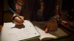 A girl works on schoolwork