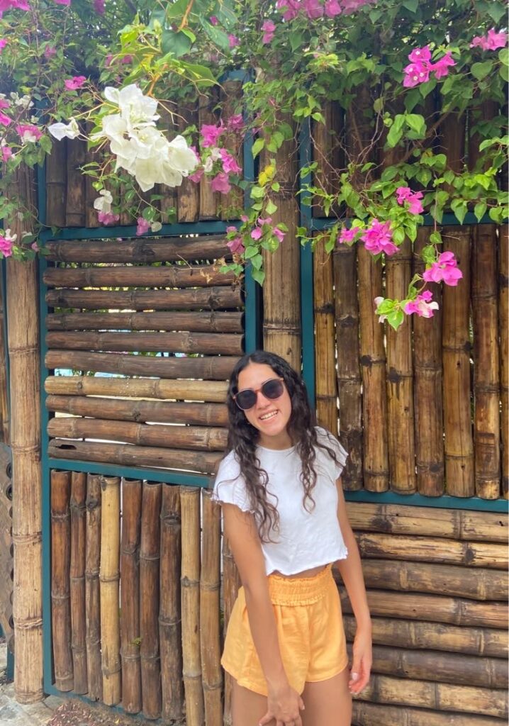 Senior Anika Bagal poses in front of a bamboo wall.