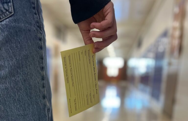 Hand holding hall pass