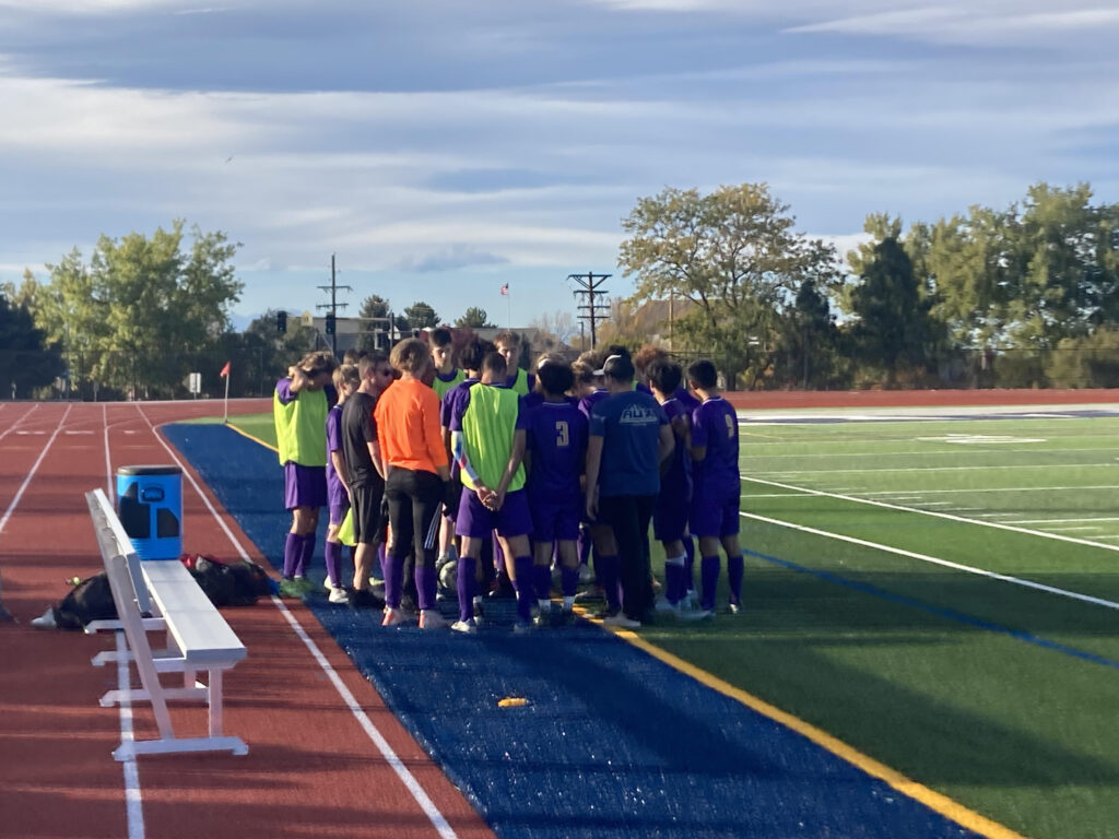 Boys Varsity Soccer Team Huddling Together