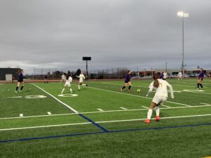 LHS and TJHS run down pitch at first girls soccer game.