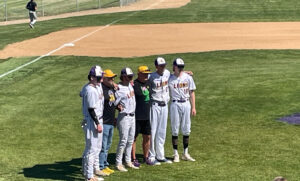 Seniors standing with the coaches on the field.