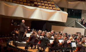 Dr. Farr conducting the orchestra, band, and choir combined.