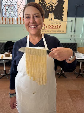 Dr. Rubin taking a pasta making class in Rome, Italy