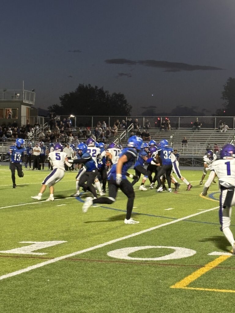 Football players running towards each other