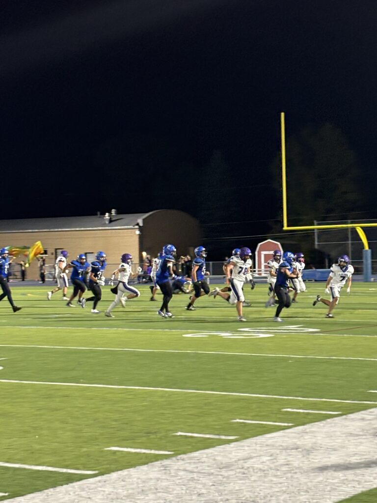 football players chasing a ball
